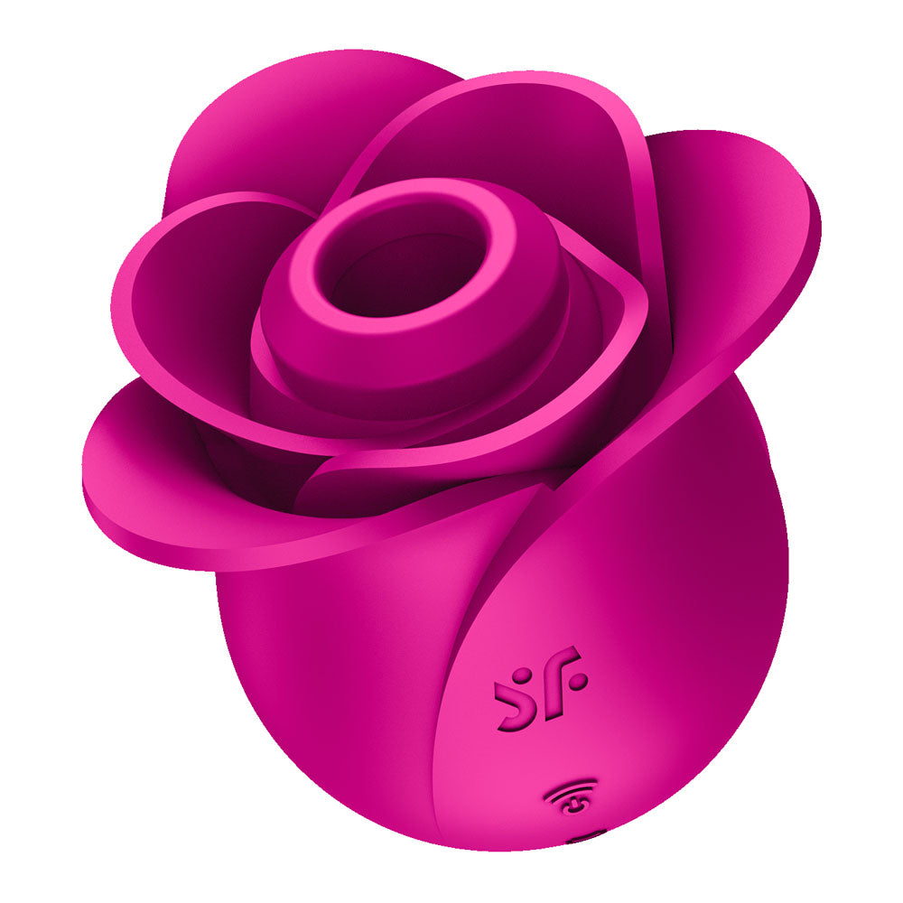 Magenta rose-shaped clitoral suction vibrator with layered petals and Satisfyer logo